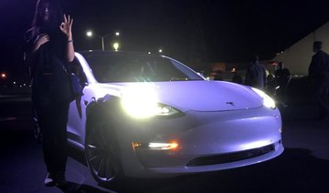 Elon Musk hands over first Tesla Model 3 electric cars to early buyers