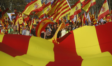 Hundreds of thousands march for unified Spain, poll shows depths of division