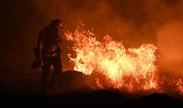 Returning winds churn up heightened alert in fire-hit California