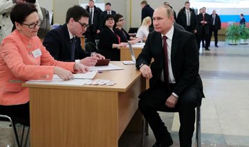 Putin on track for commanding win as Russians troop to polls