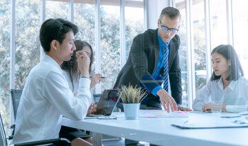 Young business people are presented marketing work project to the customer in meeting room office. (Shutterstock)