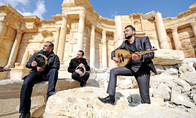 Atop Palmyra’s damaged theater, Syrian musicians sing of return