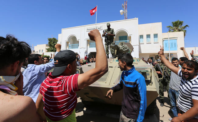 Protests turn violent in south Tunisia; police stations burned, one killed