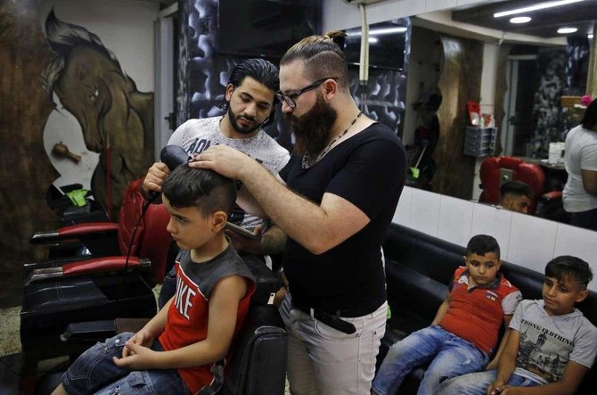 Syrian barber creates portraits on canvas — clients’ heads