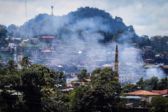 Philippine army says taking fire from women, children in Marawi battle