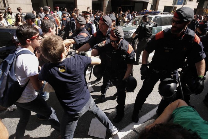 Clash over Catalan vote heats up in Spain as police swoop in