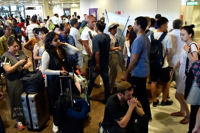 Tourists leave as Bali’s volcano-hit airport gets back to business