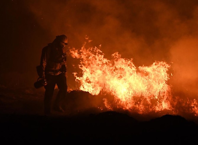 Returning winds churn up heightened alert in fire-hit California