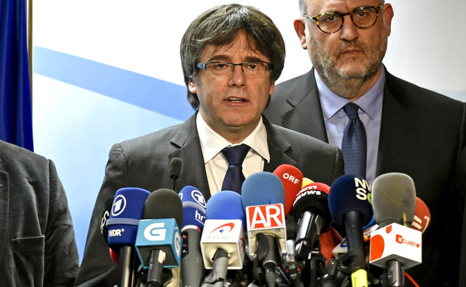 Ousted Catalan leader offers to meet PM outside Spain